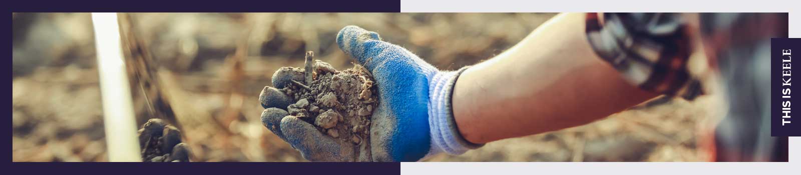 Person in field with a handful of soil