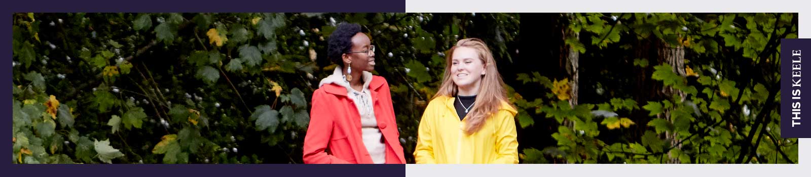2 smiling students outside among the trees on Keele campus.