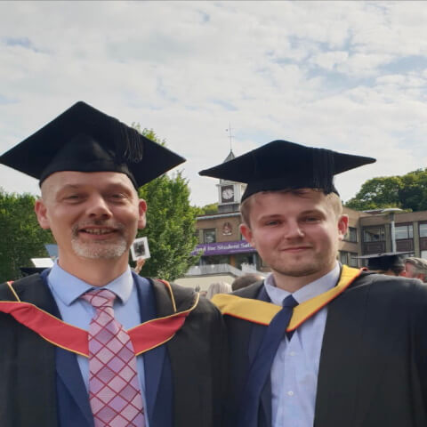 Image of Liam during graduation alongside Simon Rimmongton