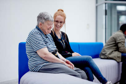 A student nurse talking to a patient.