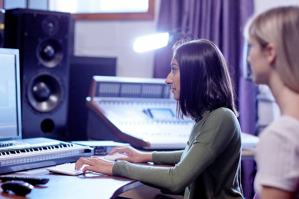 Two students sat together in studio