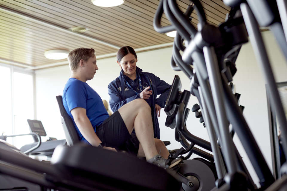 An individual on an exercise bicycle
