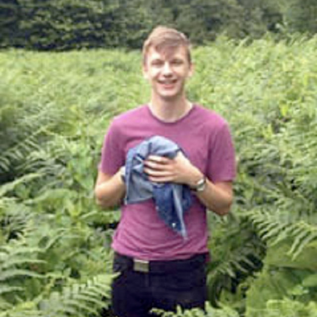 Male smiling stood in a field 