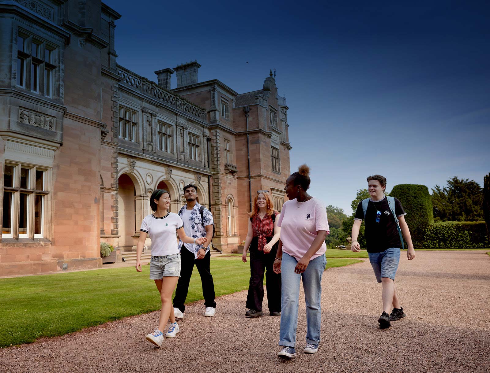 Historic Keele Hall with students walking in the grounds